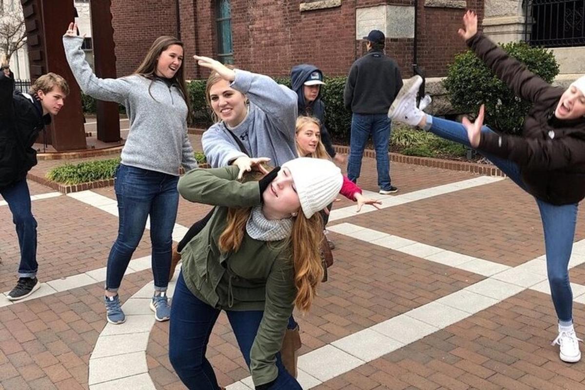 a group of people dancing in front of a building