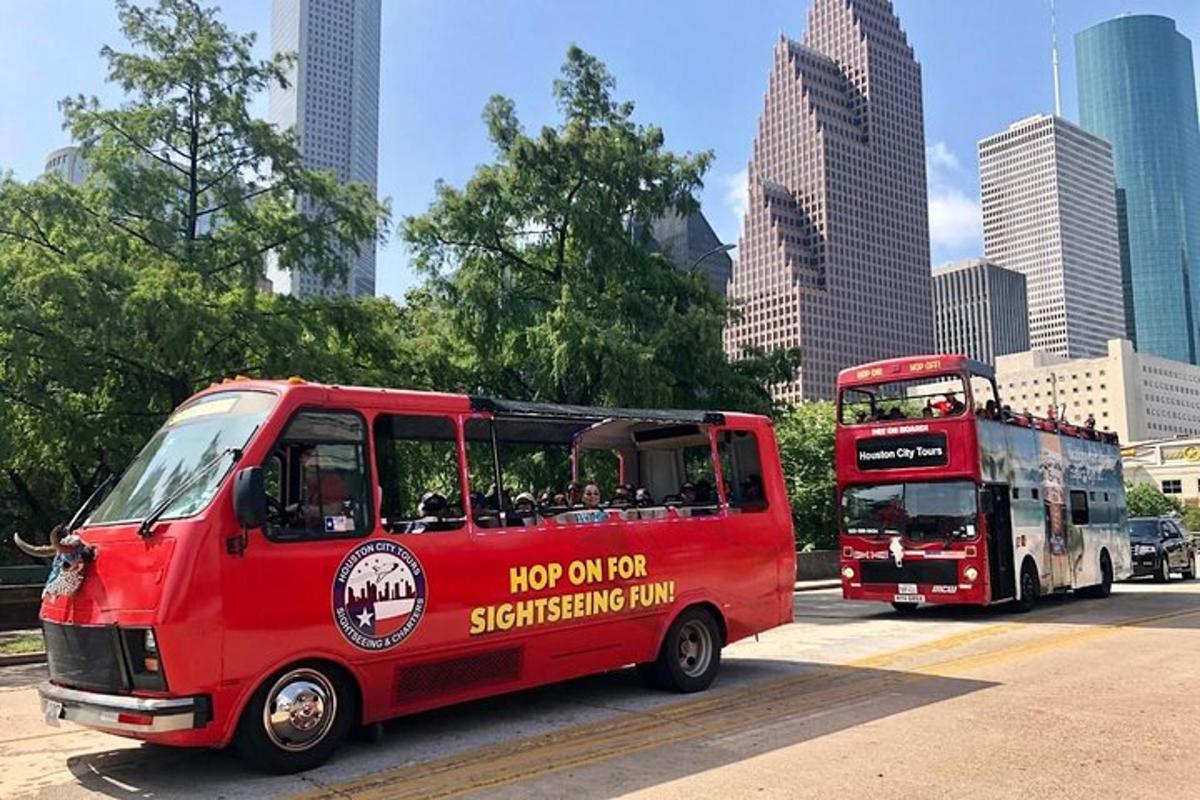 a red bus driving next to a double decker bus