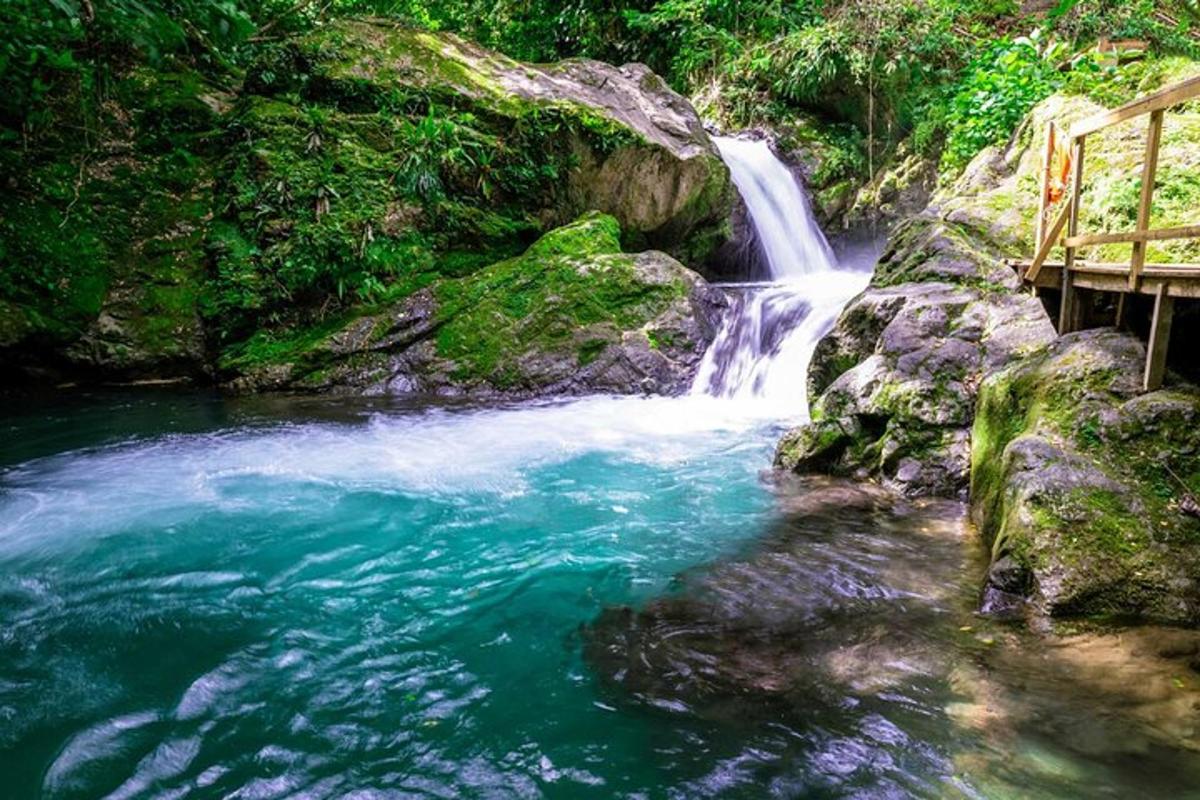 a waterfall in the middle of a river with a bench