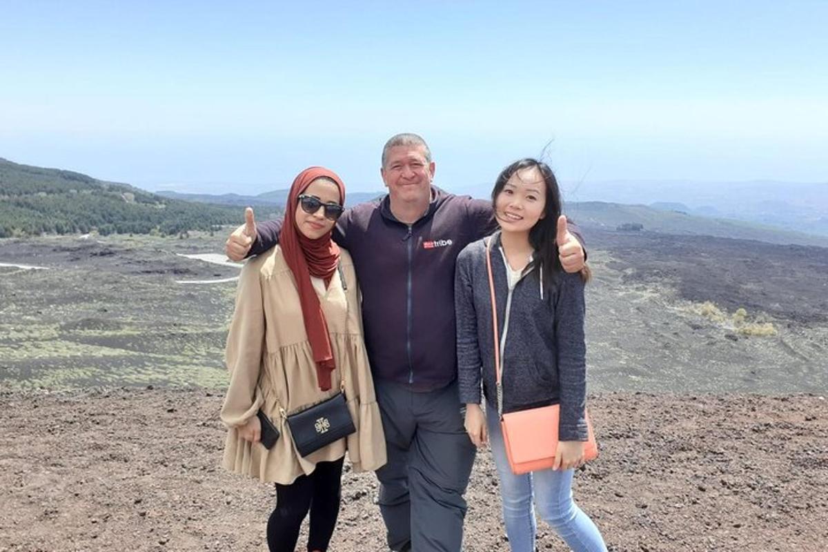 a man and two women standing on top of a mountain