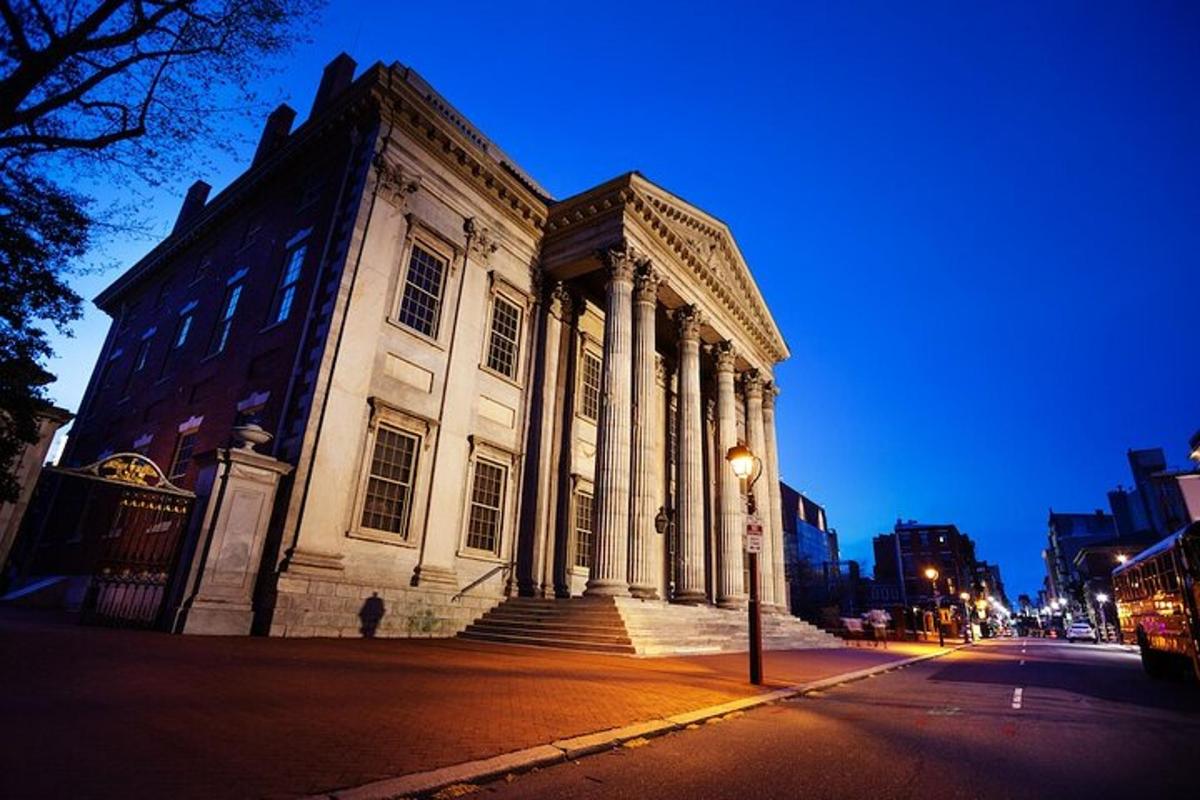 a large building with columns on the side of a street