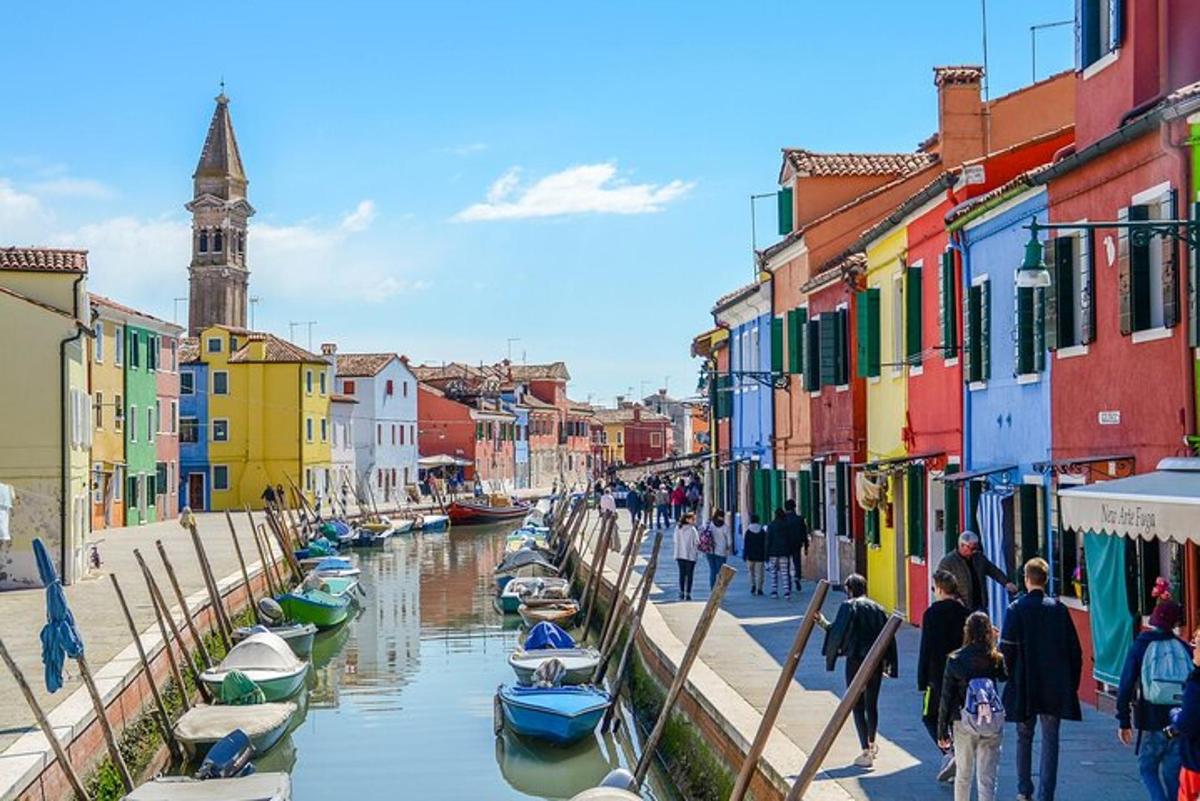 a group of boats in a canal with buildings