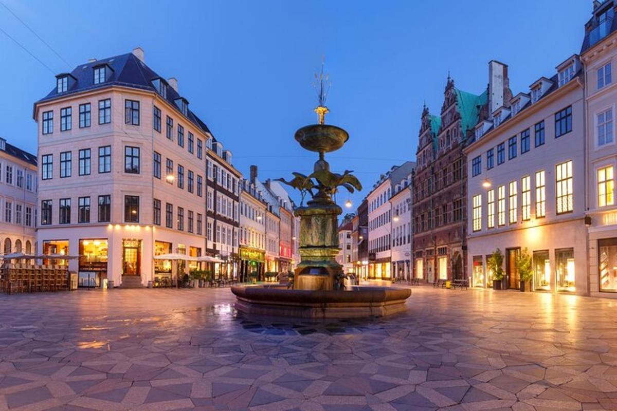 a fountain in the middle of a street with buildings