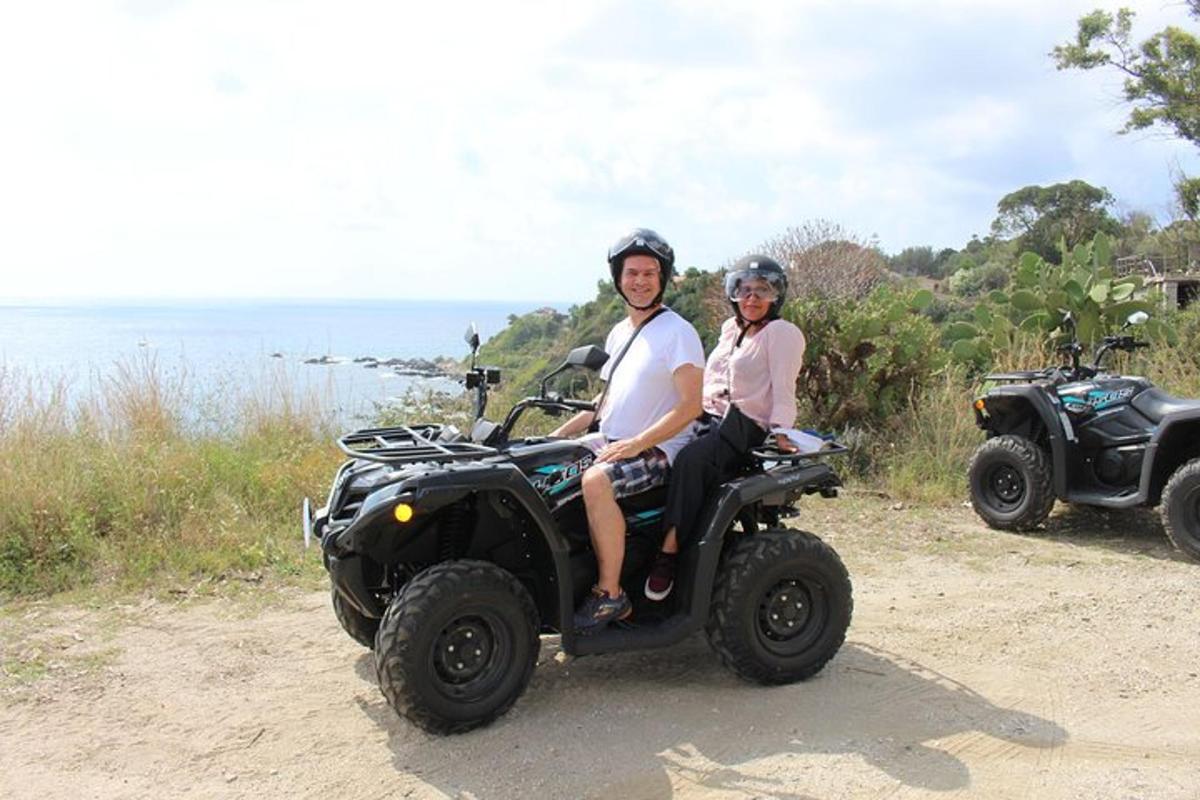 a man and a woman riding on a four wheeler