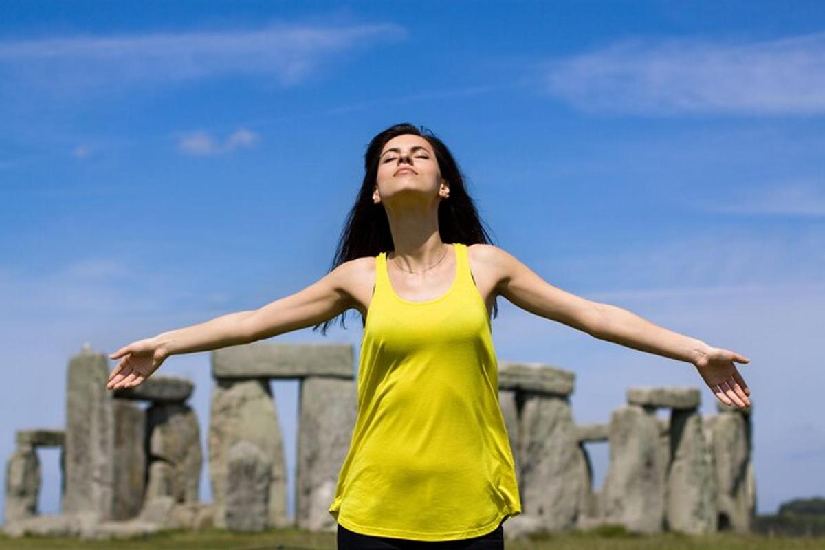 a woman in a yellow shirt with her arms out