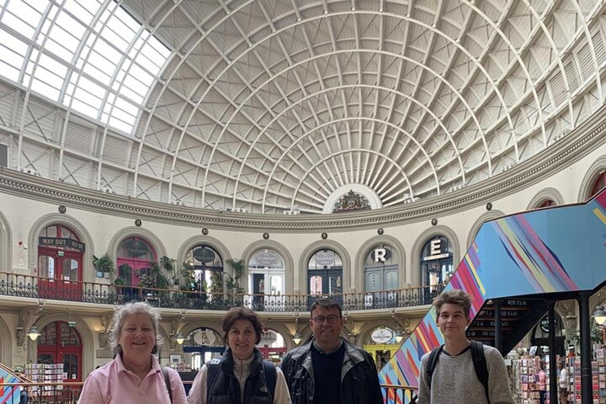 a group of people standing in a building with a ceiling