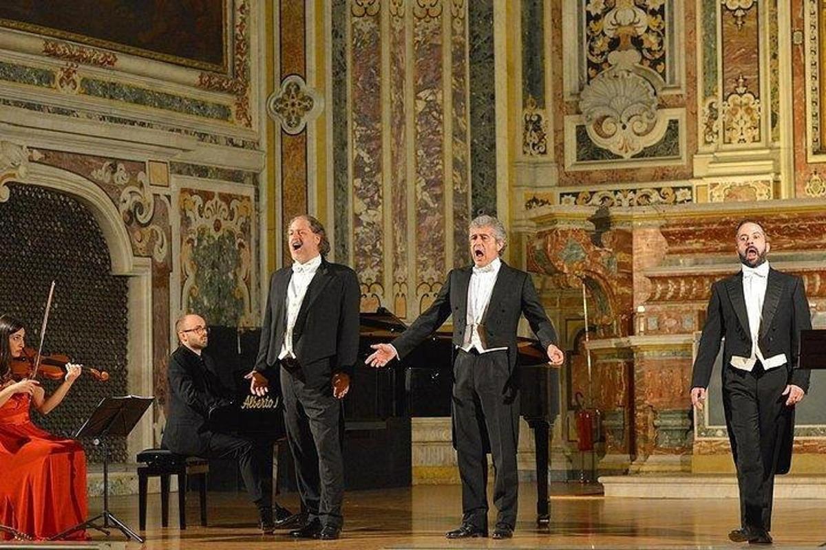 three men in suits walking in a room with a orchestra