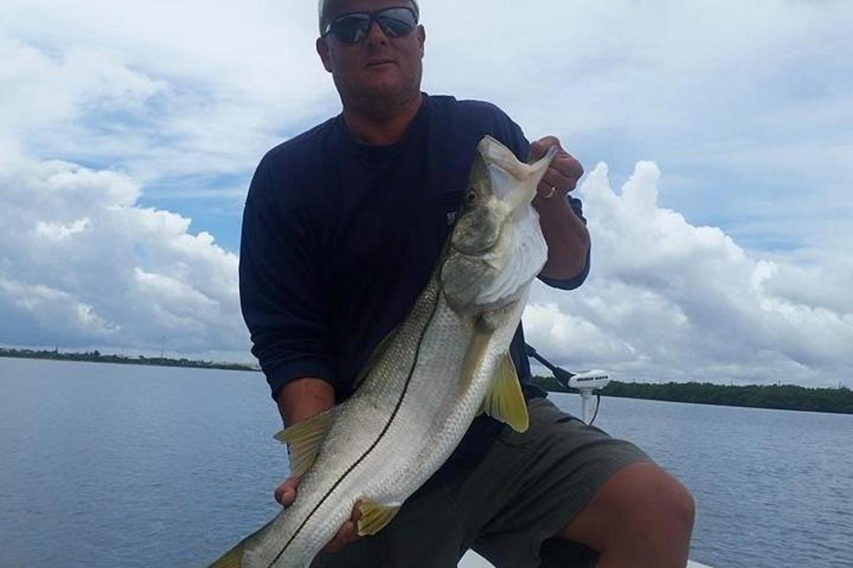 a man holding a fish in his hand