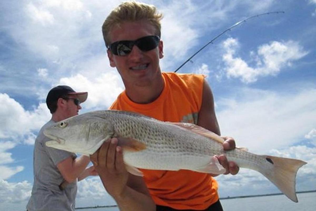 a man holding a large fish in his hands