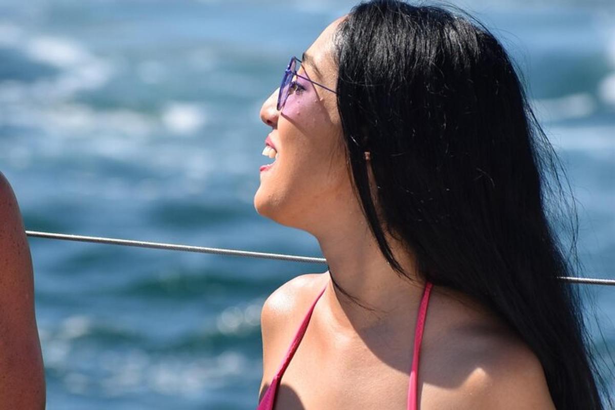 a woman in a red bikini standing next to the water