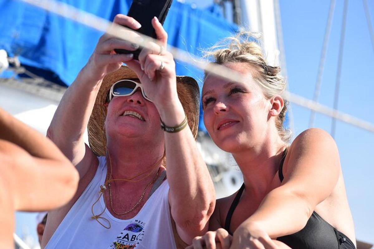 two women taking a picture with a cell phone