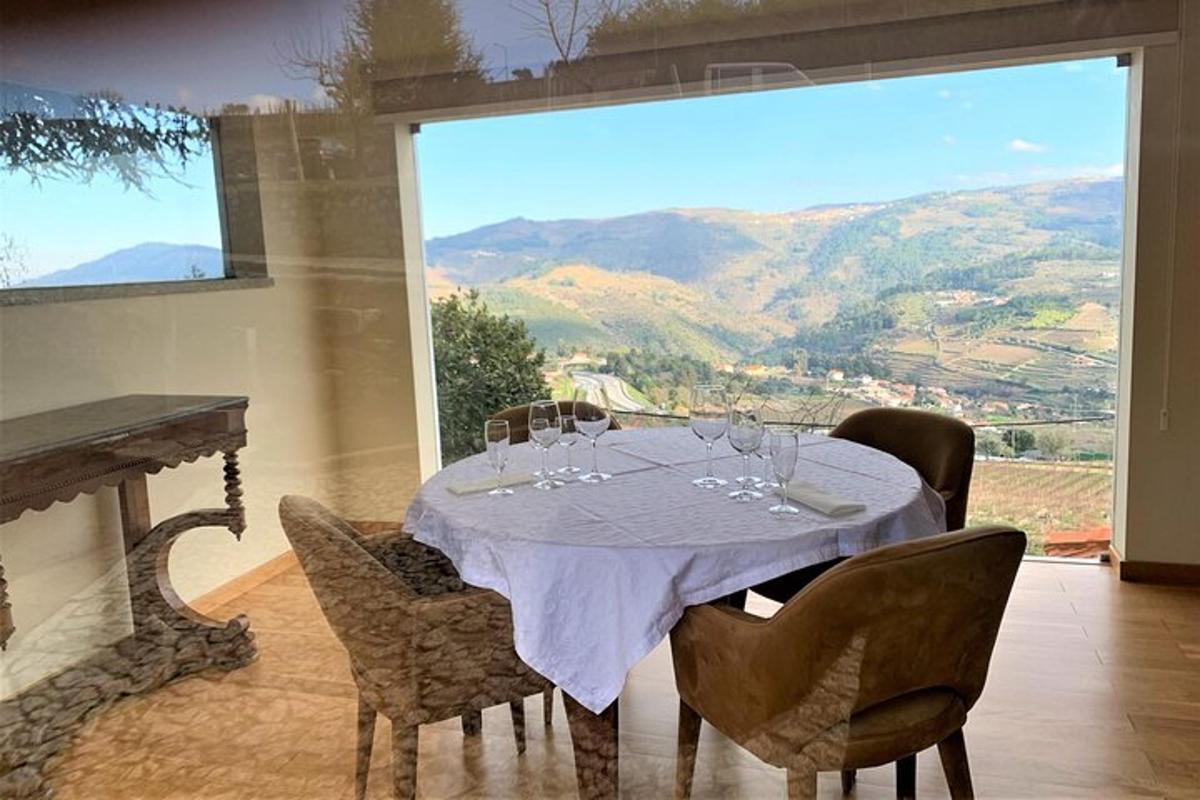 a dining room with a table with wine glasses on it