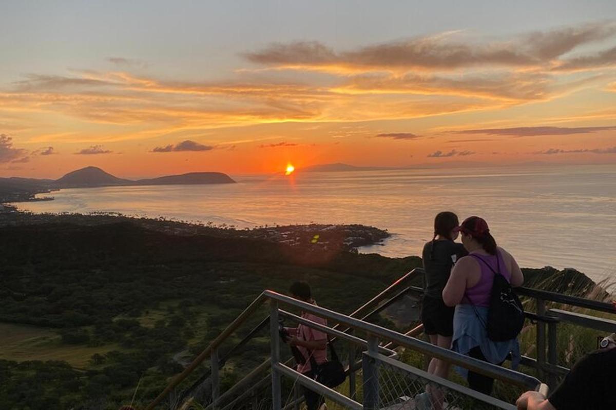 a group of people looking at the sunset