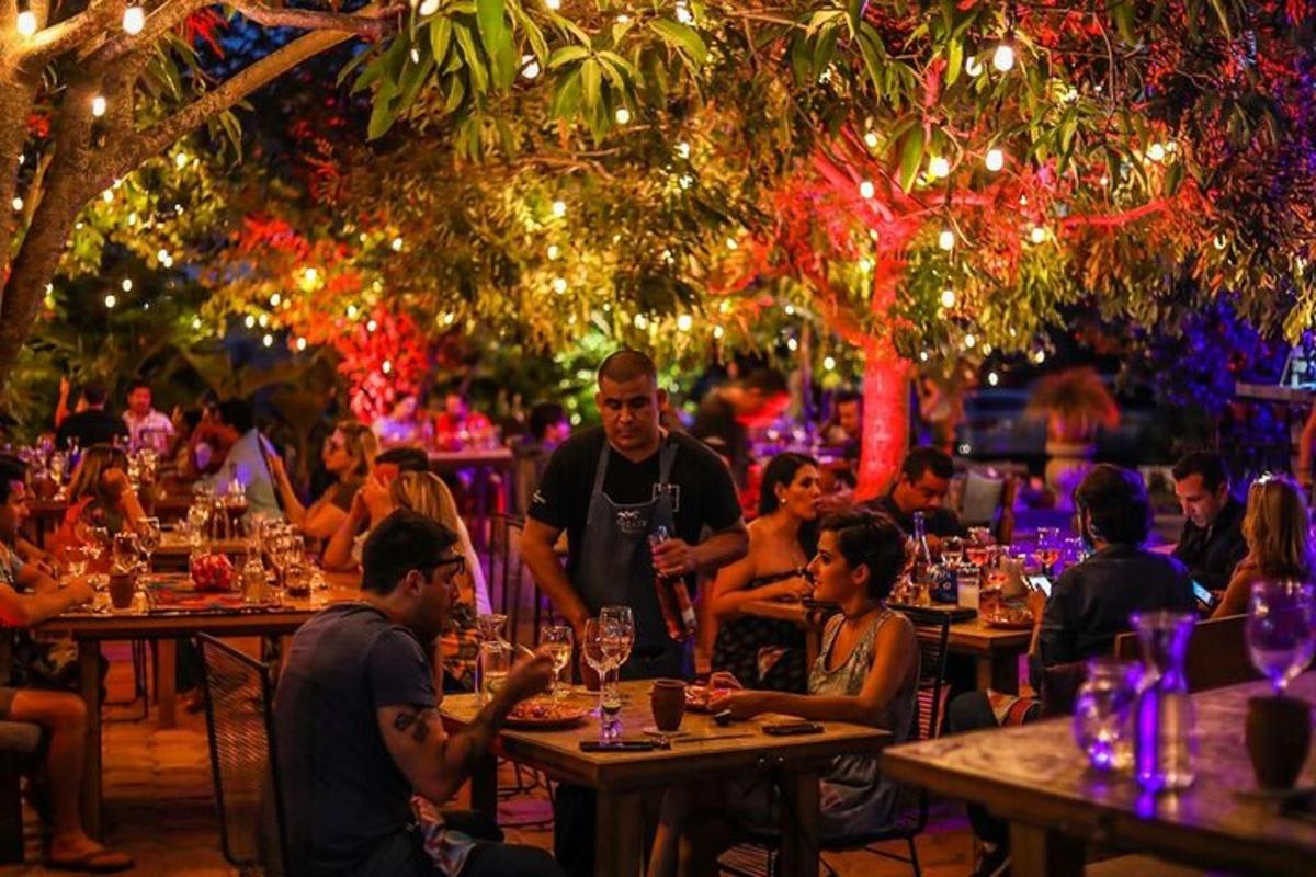 a group of people sitting at tables in a restaurant