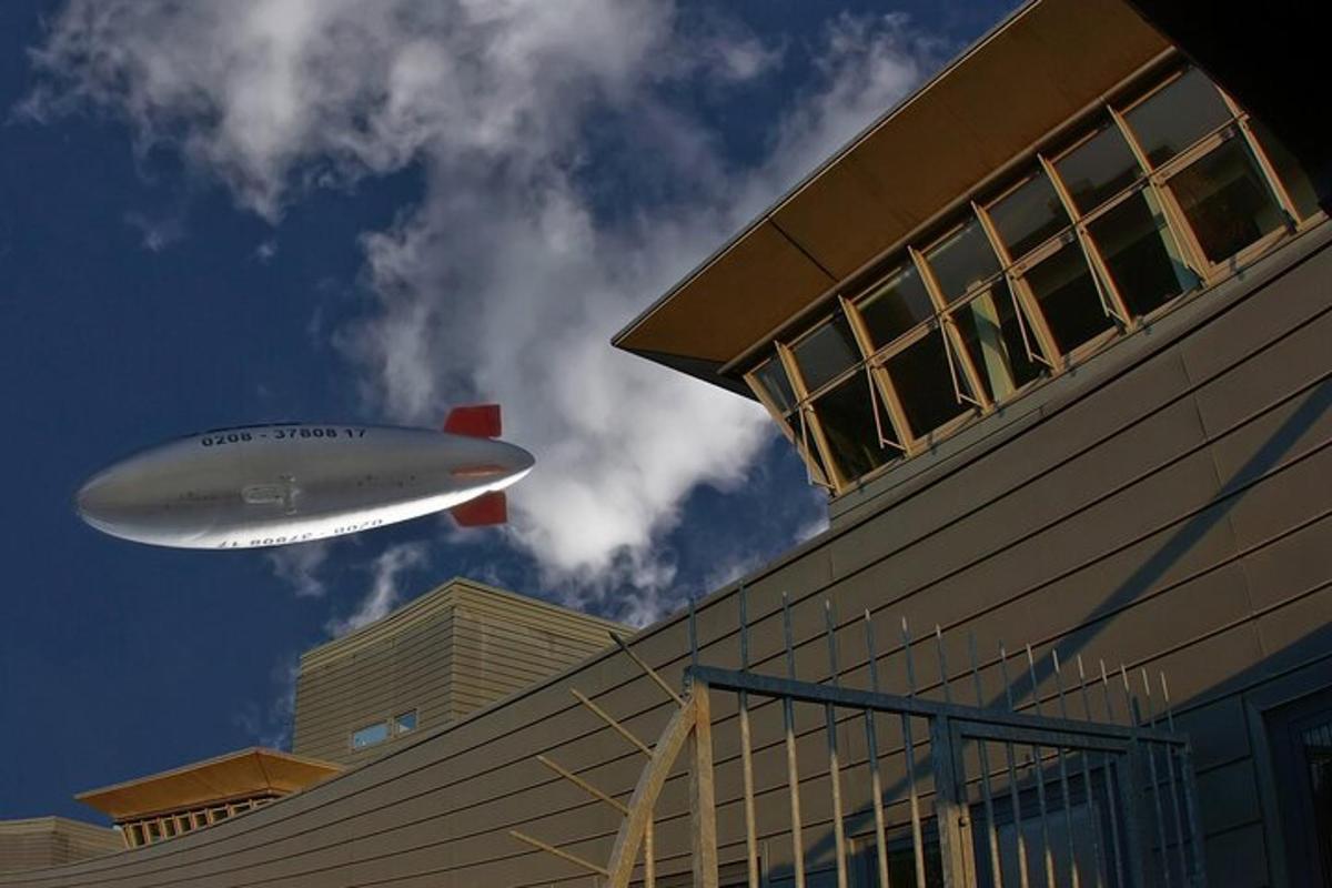 a plane flying over a building with a building