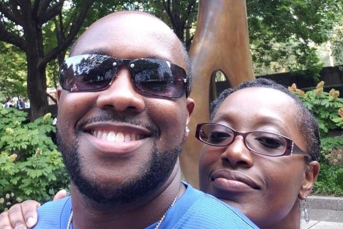 a man and a woman standing in front of a statue