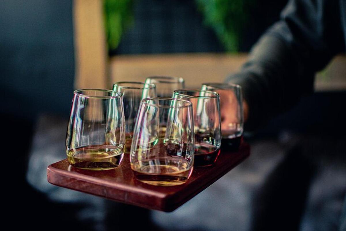a group of wine glasses sitting on a wooden tray