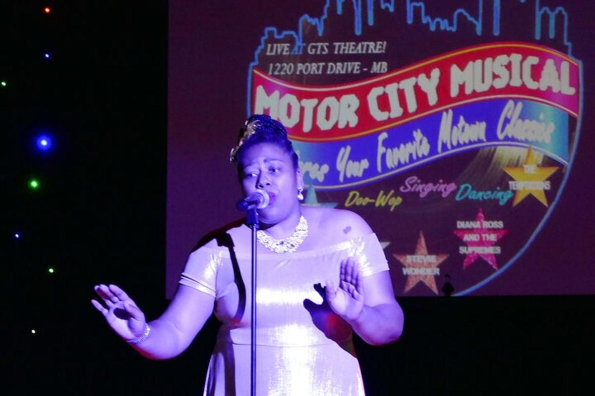 a woman standing on a stage with a microphone