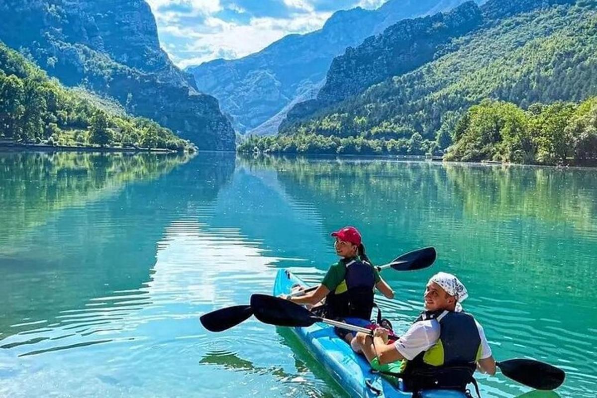 two people are in a kayak on a lake
