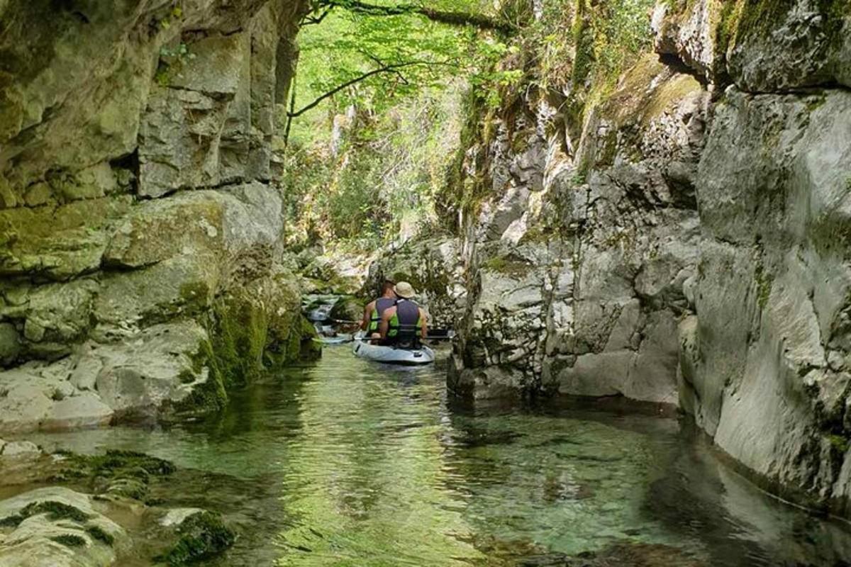 a person kayaking down a river in a cave
