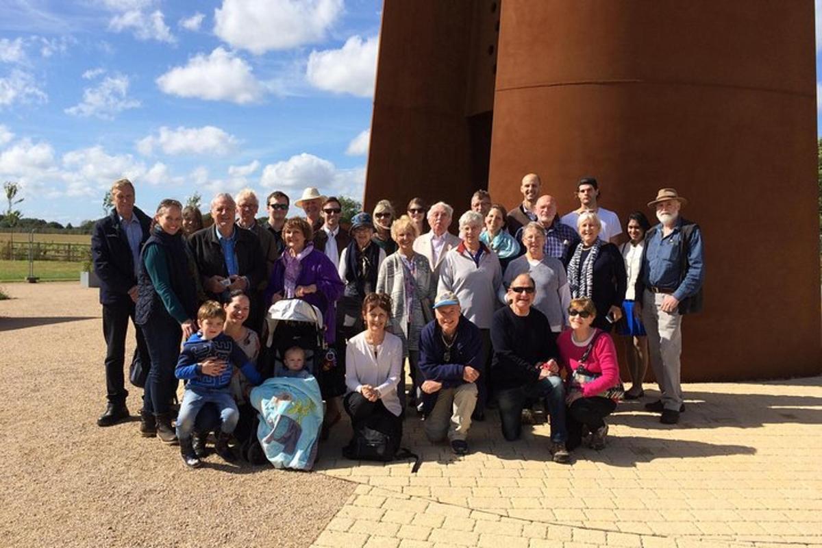 a group of people posing for a picture in front of a building