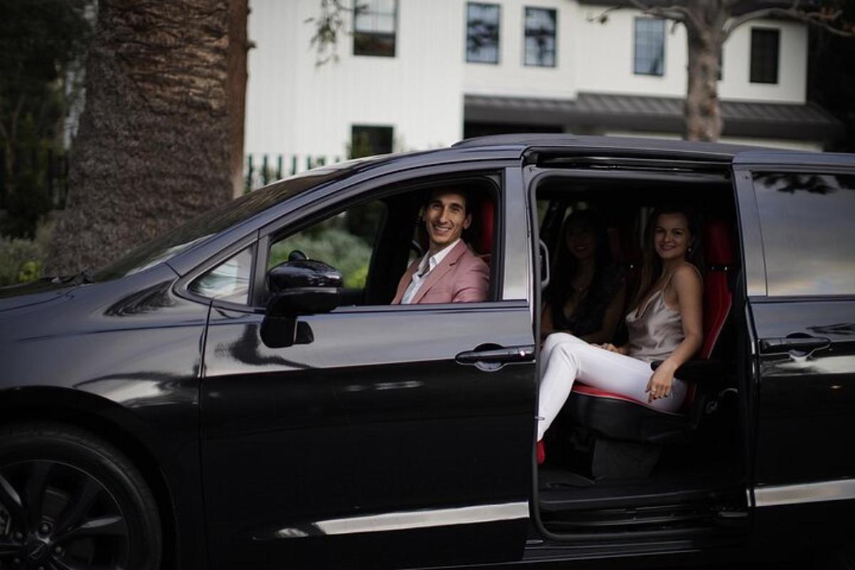 a man and two women sitting in a car