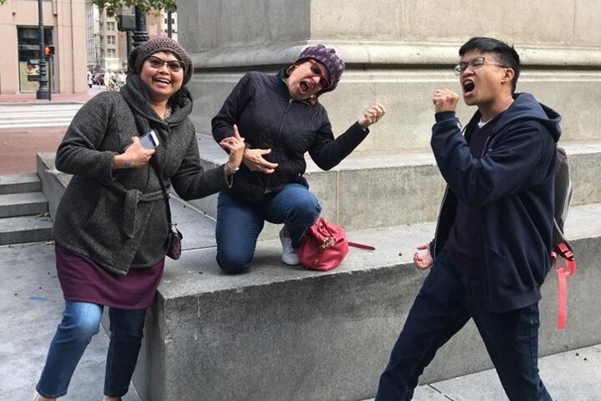 a group of three people standing on a concrete ledge