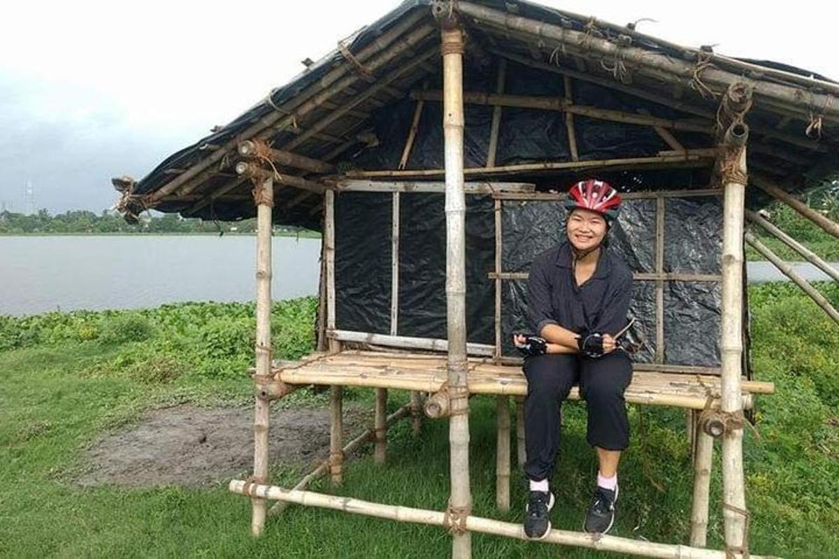 a woman wearing a helmet sitting in a hut