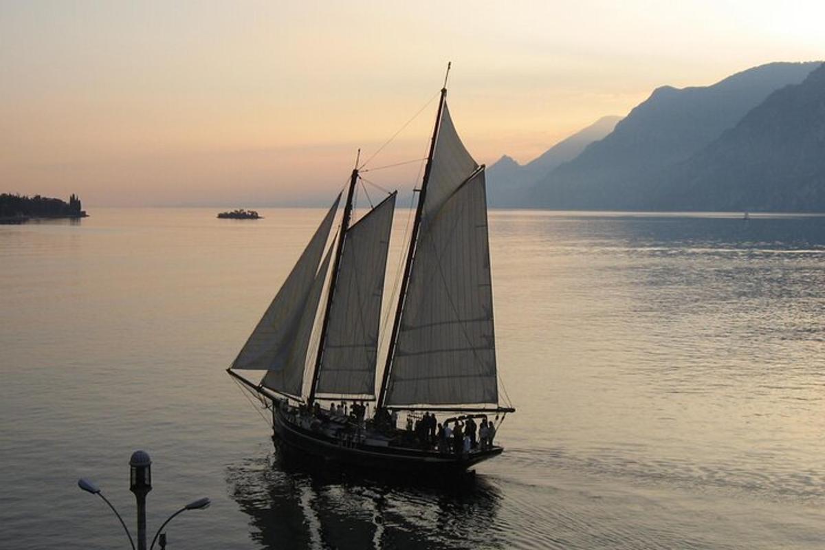 a group of people on a sail boat in the water
