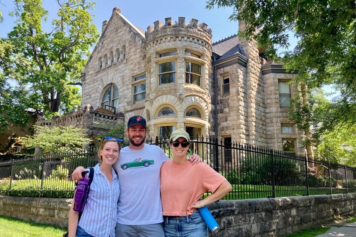 a group of people standing in front of a mansion