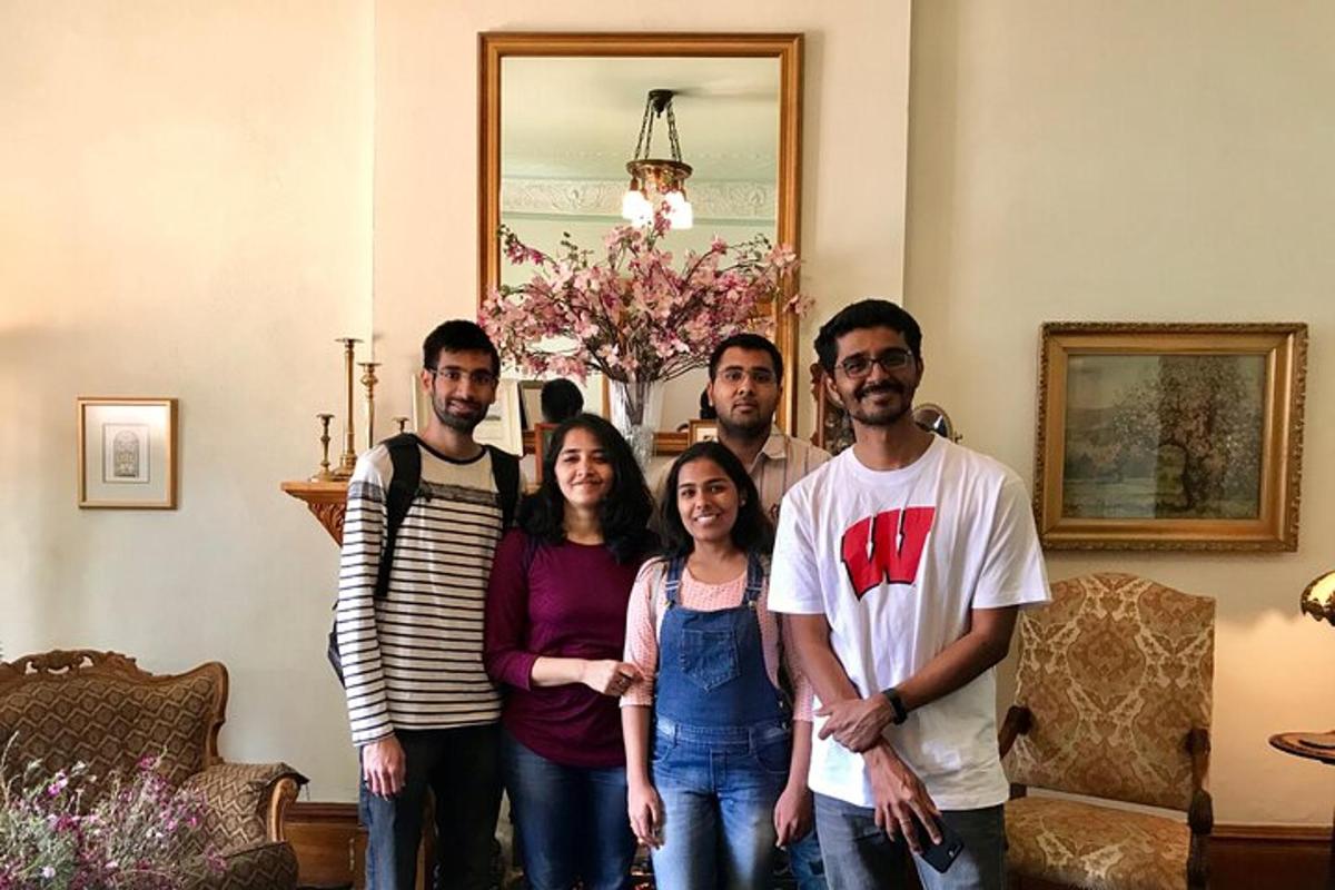 a group of people posing for a picture in a living room