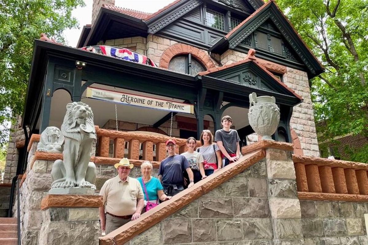 a group of people posing in front of a building
