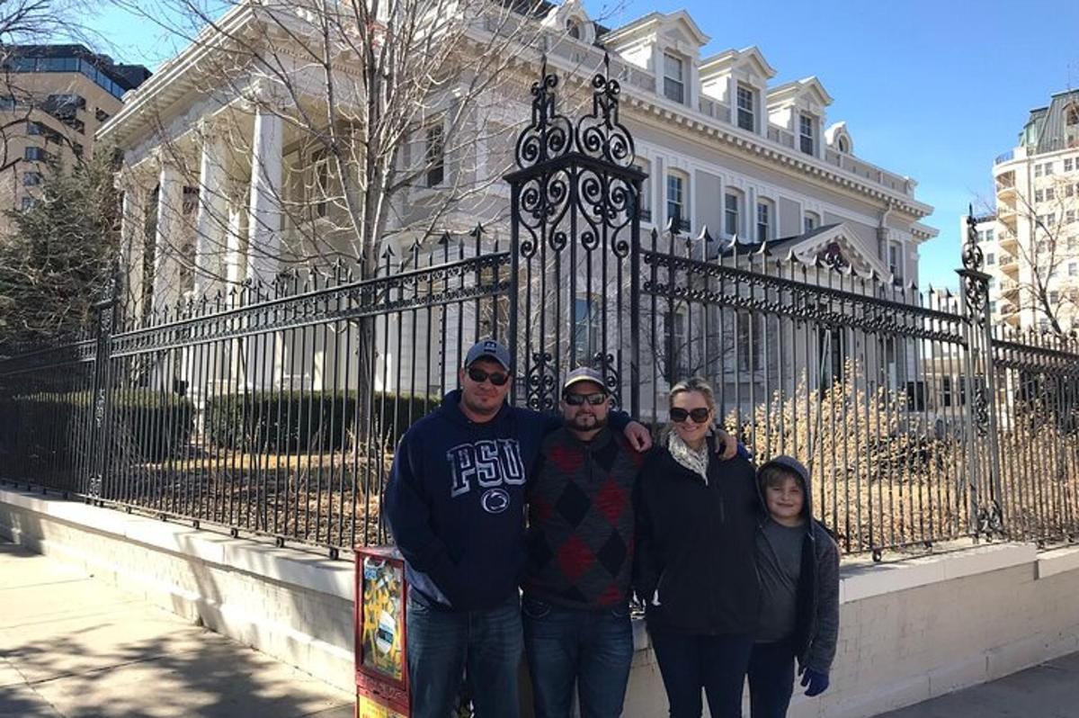 a group of people standing in front of a fence