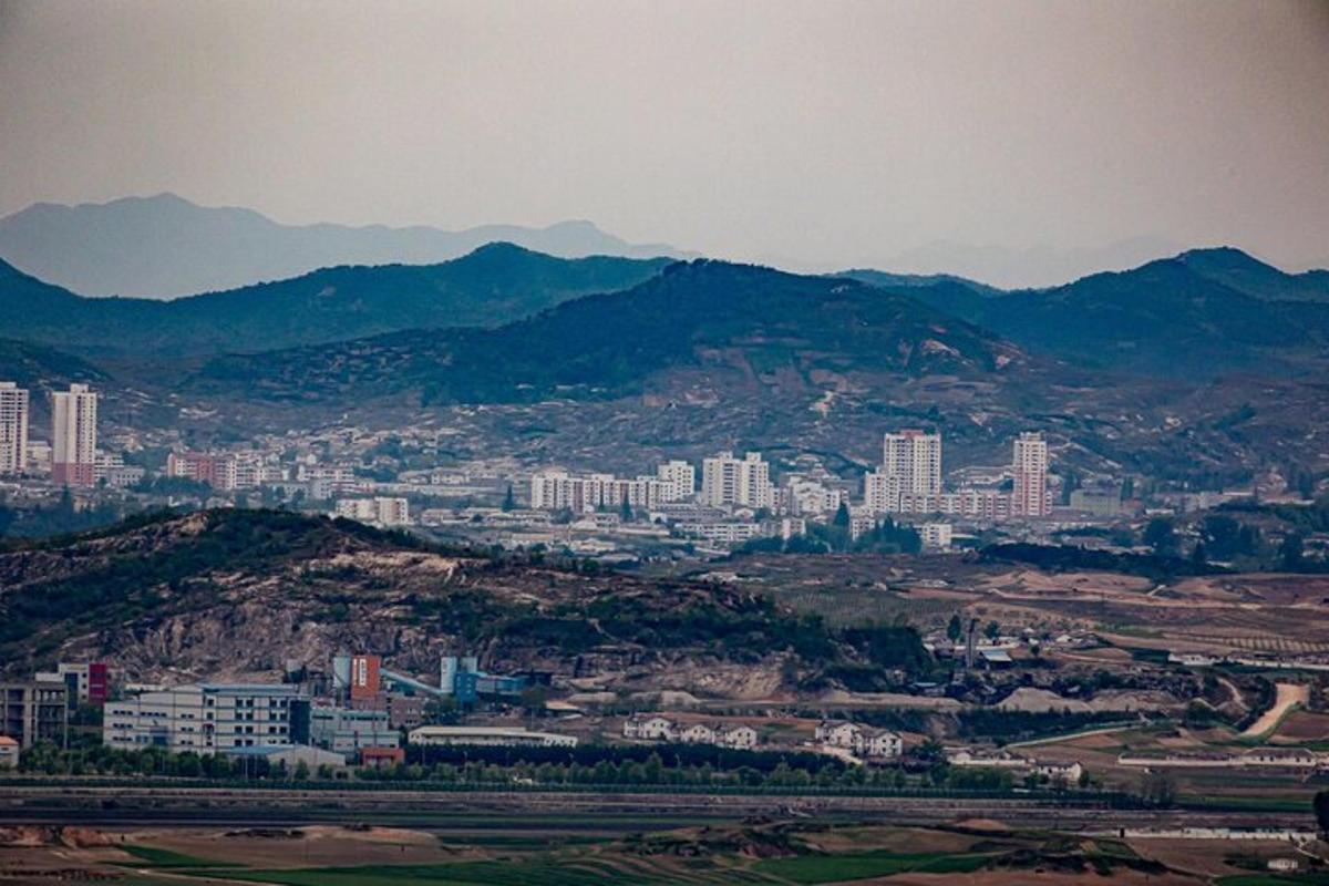 a view of a city with buildings and mountains
