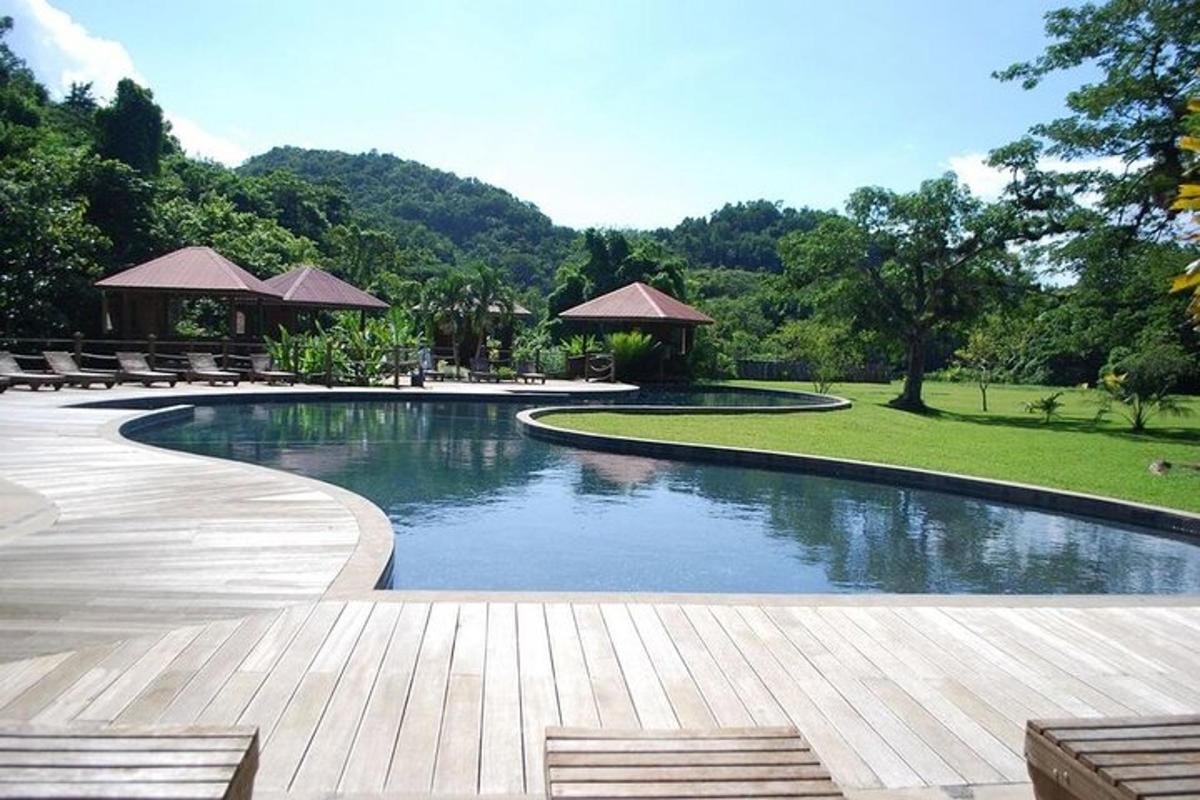 una piscina in un parco con panchine e alberi