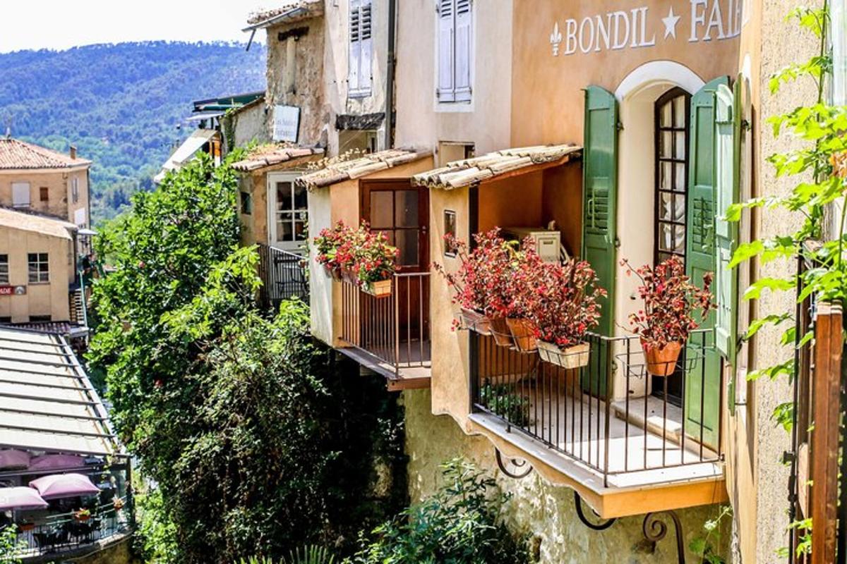 a group of buildings with flowerpots on their balconies