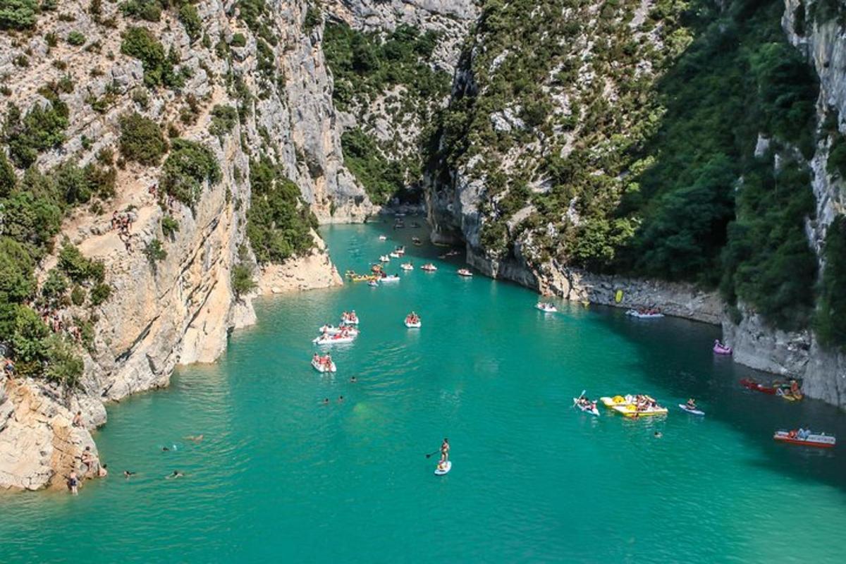 a group of boats in a river in a canyon