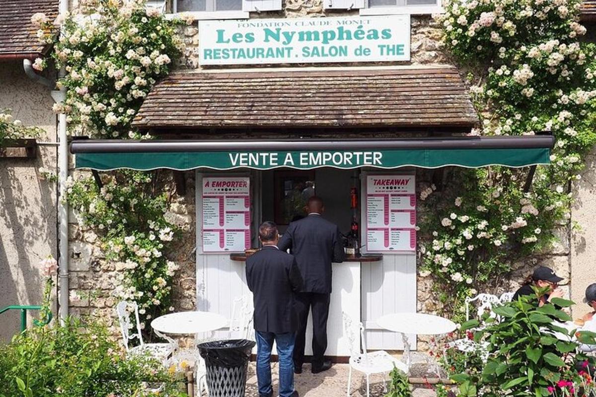two men are standing in the doorway of a restaurant sidx sidx