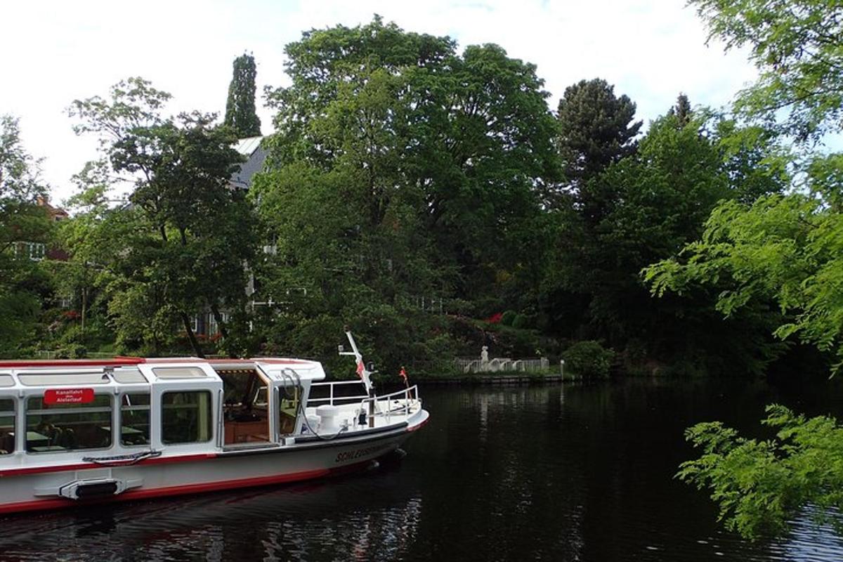 a boat traveling down a river with trees