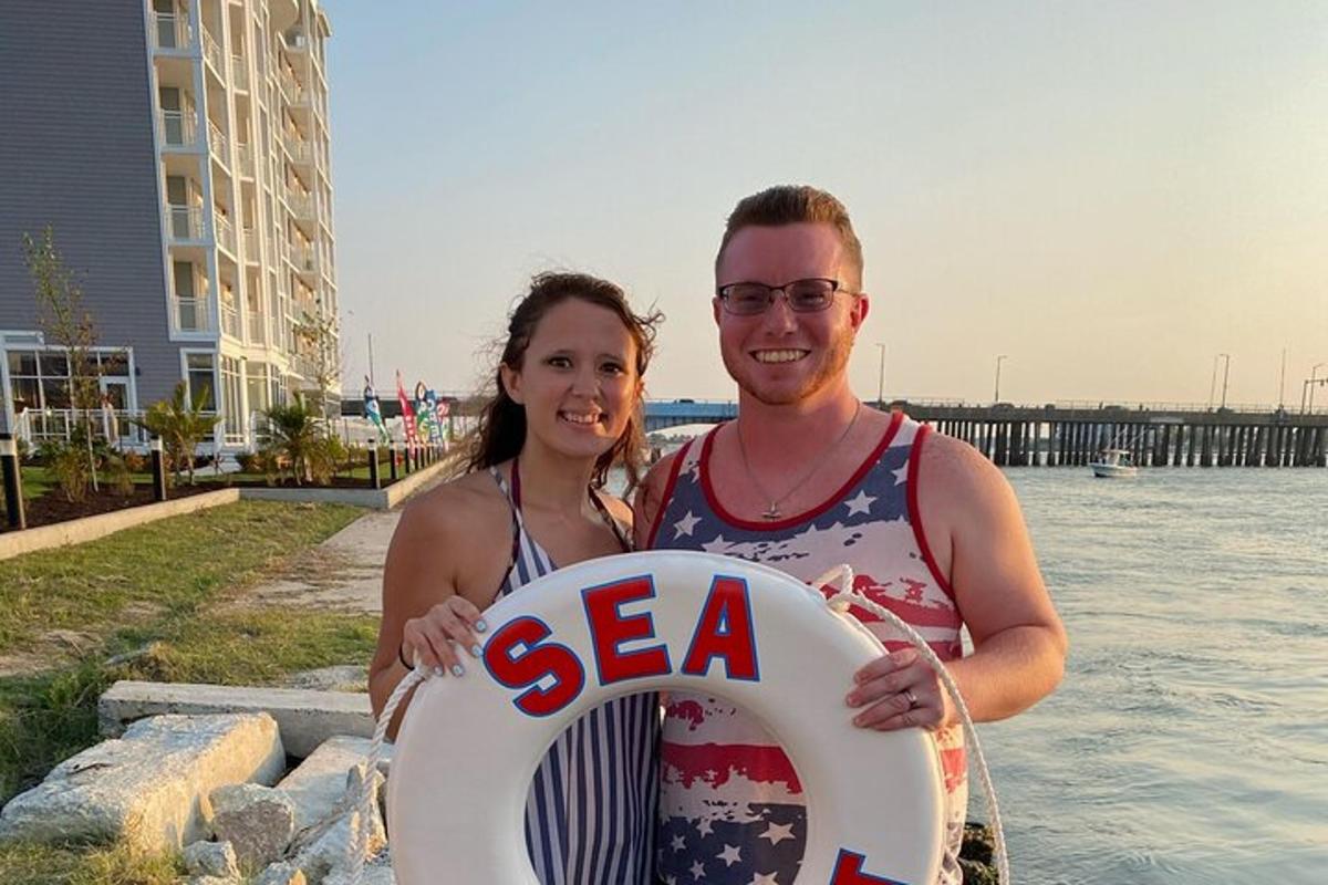 a man and a woman holding a white frisbee