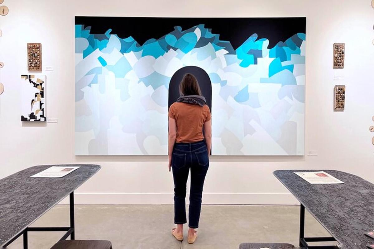 a woman is looking at a piece of art in a museum