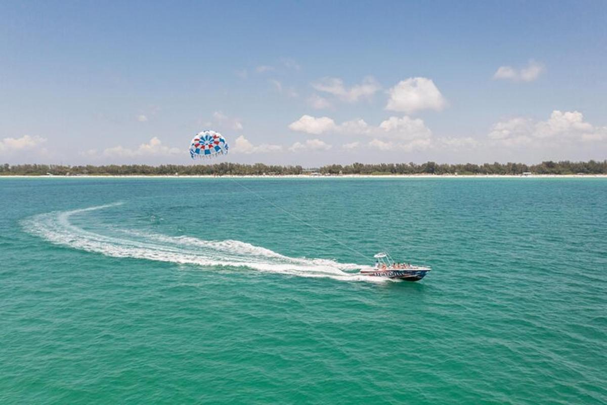 a small boat in the water with a balloon