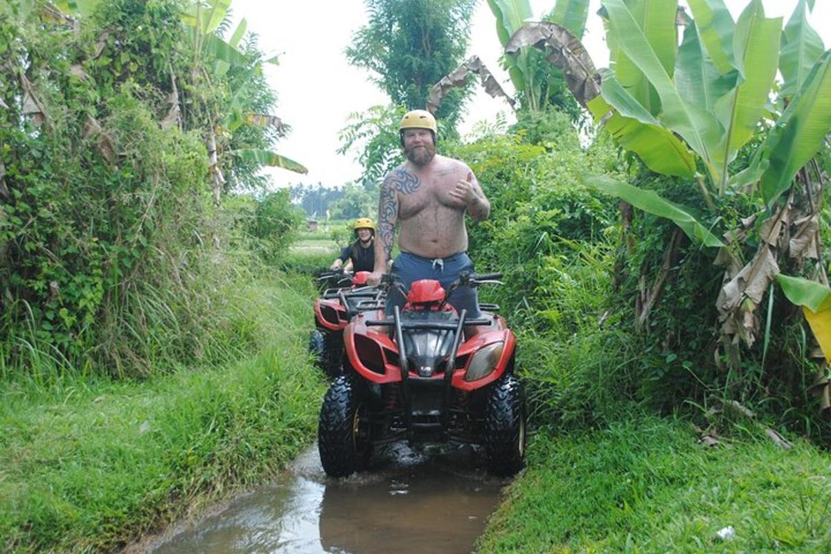 a man on a four wheeler in the mud