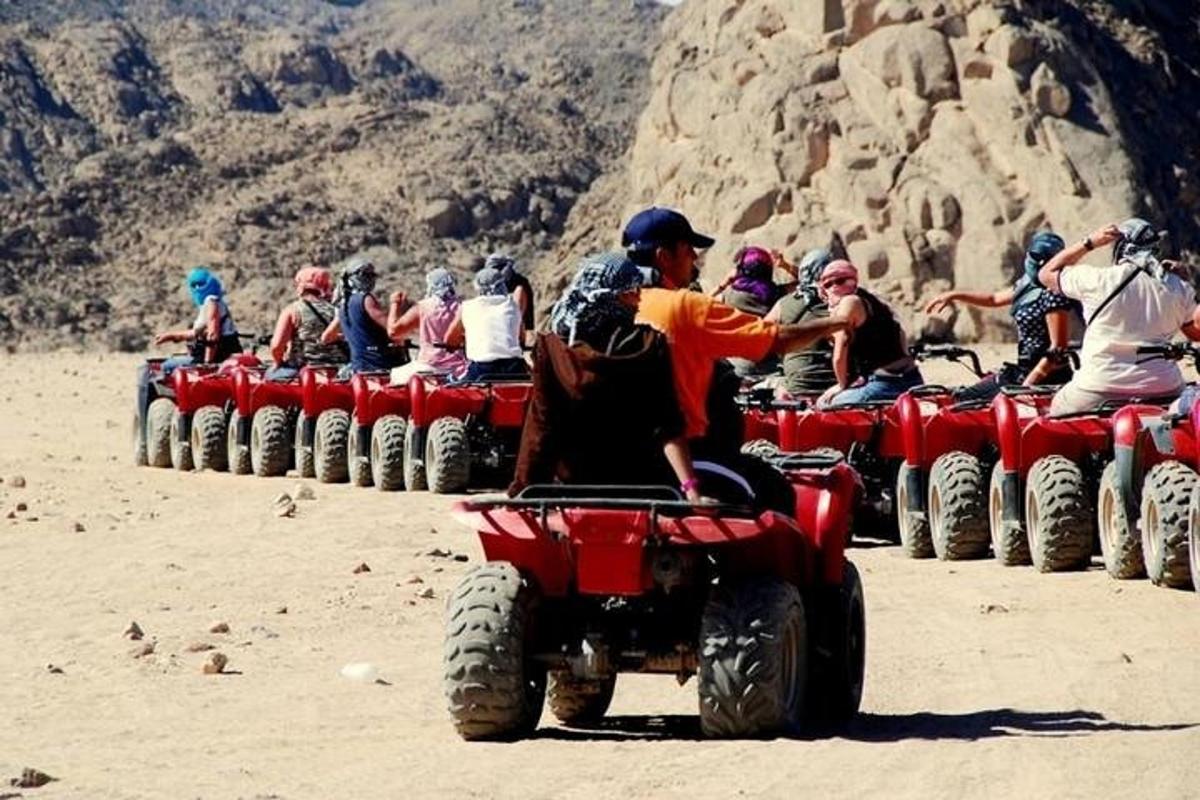 a group of people riding on atvs in the desert