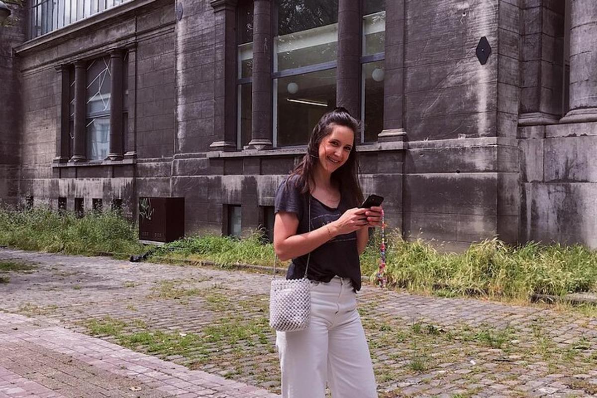 a woman holding a cell phone in front of a building