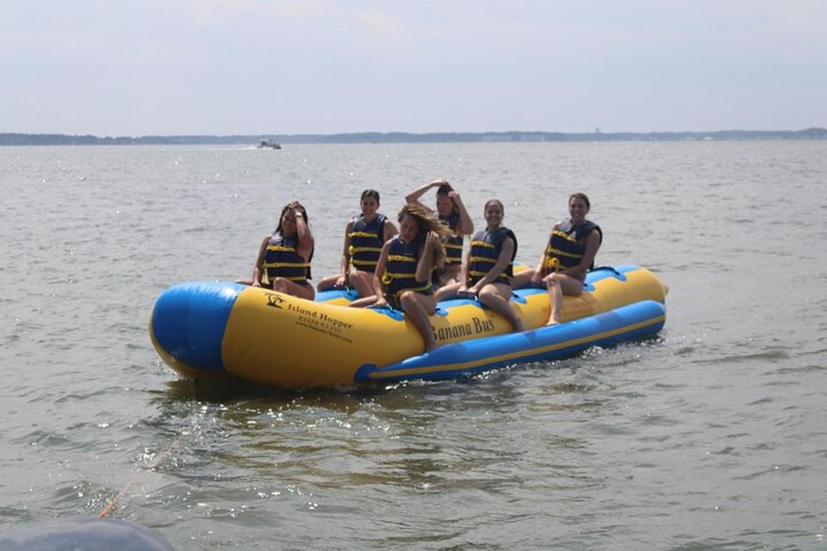 a group of people sitting on a raft in the water