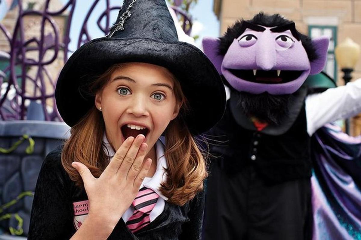 a woman in a witch hat and a mascot