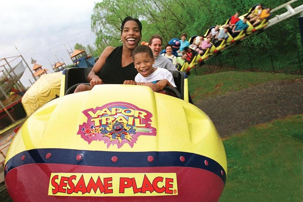 a man and a child riding on a roller coaster