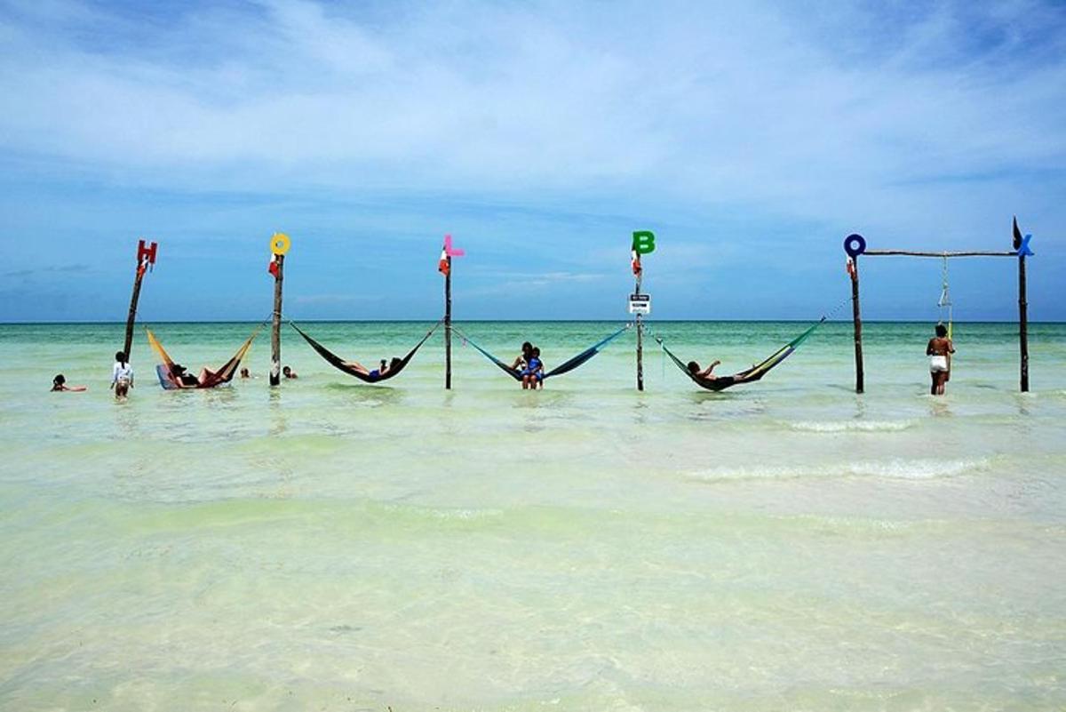 a group of people laying in hammocks in the ocean