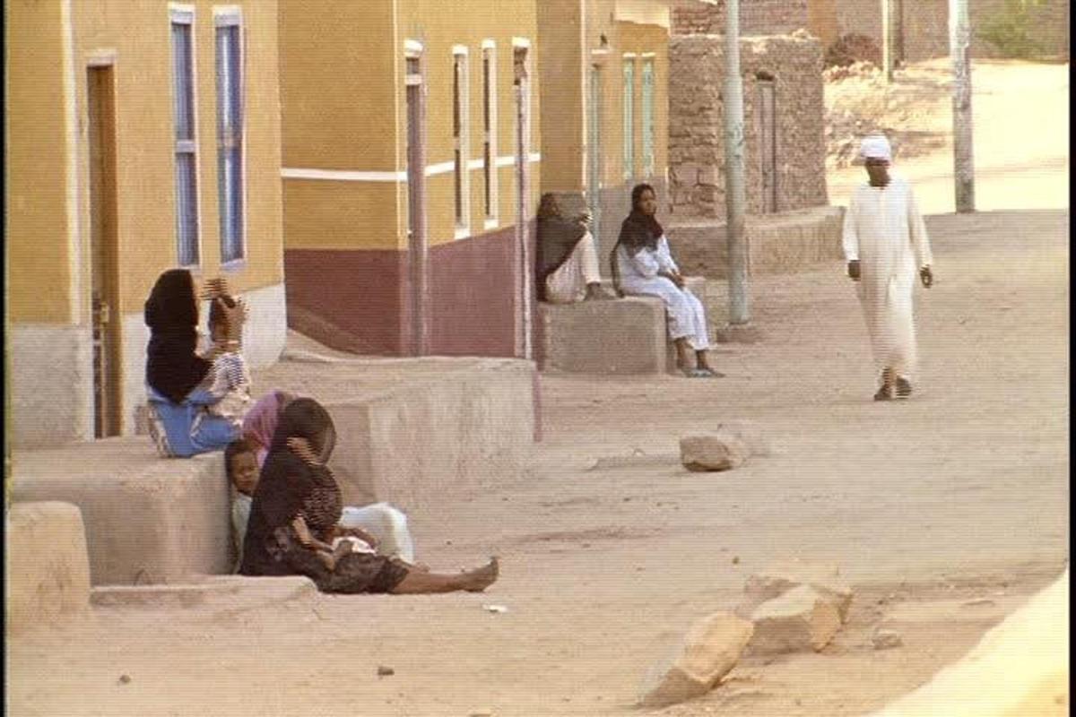 a group of people sitting outside of a building